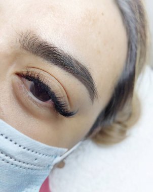 Eyelash extensions in beauty salon macro eye Kim effect 