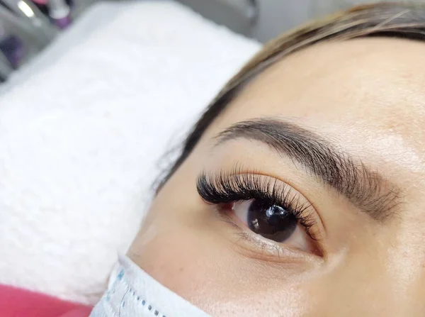 Eyelash extensions in beauty salon macro eye Kim effect