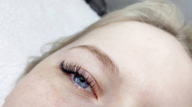 Eyelash extensions in beauty salon macro eye Kim effect 