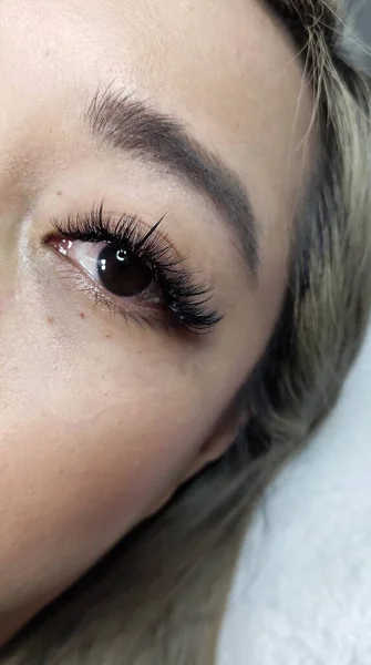 Eyelash extensions in beauty salon macro eye Kim effect