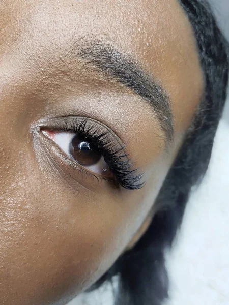 Eyelash extensions in beauty salon macro eye Kim effect