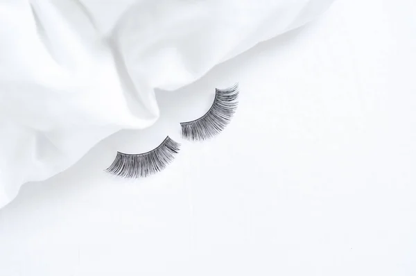 close up of strip fake lashes on the bed, without make up concept. High quality photo