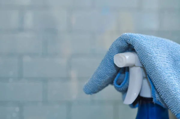 blue bottle of spray for cleaning windows and surfaces and a rag,equipment for wiping dust