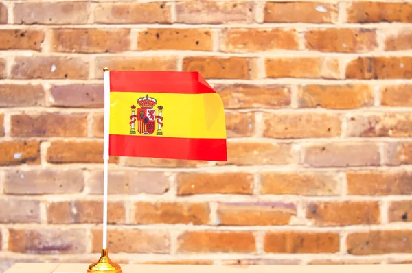 close up of National Spanish flag yellow and red colors,hand holding flag.