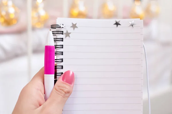 Notebook and a pen for making appointment on eyelash extensions in beauty salon. High quality photo