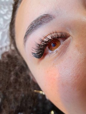 Eyelash extensions in beauty salon macro eye close up . High quality photo