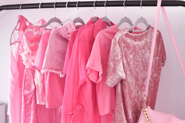 Pink woman's clothes in fitting room ,summer and spring look for girls. High quality photo