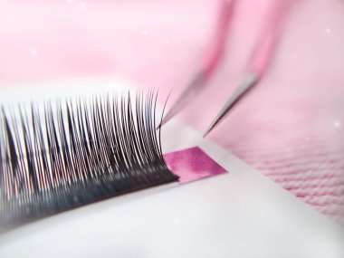 Mink lashes for eyelash extensions on pink background,beauty equipment . High quality photo