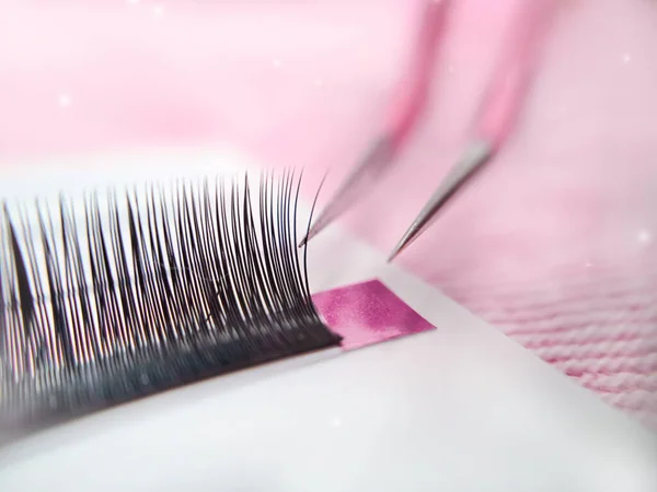 Mink lashes for eyelash extensions on pink background,beauty equipment . High quality photo