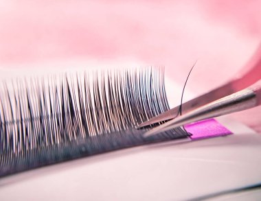 Mink lashes for eyelash extensions on pink background,beauty equipment . High quality photo