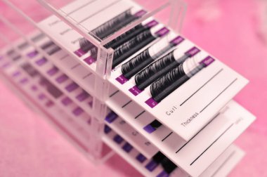 Mink lashes for eyelash extensions on pink background,beauty equipment . High quality photo