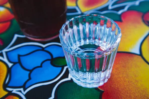 A glass of Mezcal on the table at an Oaxacan restaurant bar in Oaxaca City, Mexico.