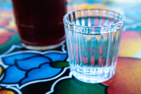 A glass of Mezcal on the table at an Oaxacan restaurant bar in Oaxaca City, Mexico.