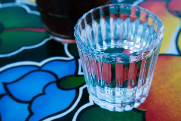 A glass of Mezcal on the table at an Oaxacan restaurant bar in Oaxaca City, Mexico.