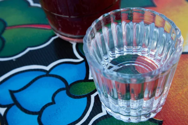 A glass of Mezcal on the table at an Oaxacan restaurant bar in Oaxaca City, Mexico.
