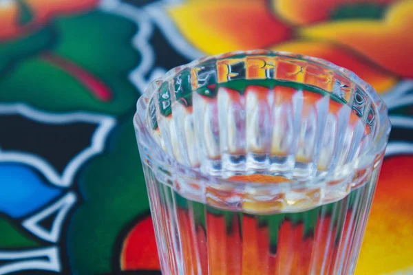 A glass of Mezcal on the table at an Oaxacan restaurant bar in Oaxaca City, Mexico.