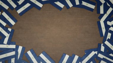 Ahşap masaya yerleştirilmiş Nikaragua 'nın kağıt bayraklarından yapılmış çerçeve. Ulusal kutlama konsepti. 3B illüstrasyon