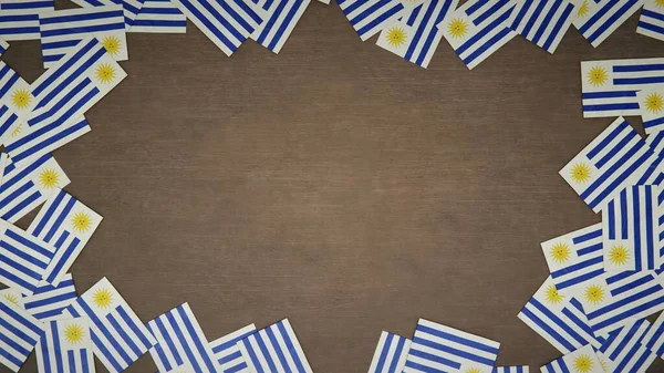 Ramka Wykonana Papierowych Flag Urugwaju Ułożonych Drewnianym Stole Krajowa Koncepcja — Zdjęcie stockowe
