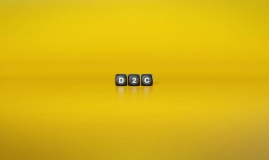 Kısaltma D2C ya da doğrudan tüketiciye yazılışı koyu tahta bloklar üzerinde düz sarı arkaplana karşı beyaz metinlerde