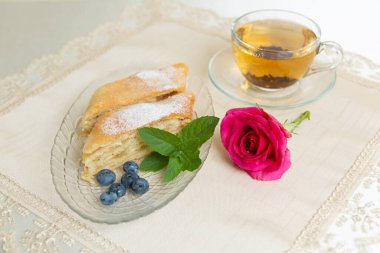 Appetizing apple pie and blueberries decorated with mint leaves