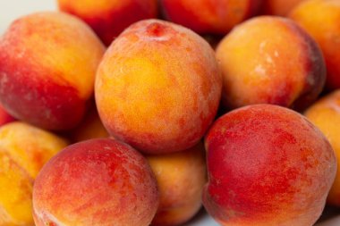 There is a dish of peaches on the table