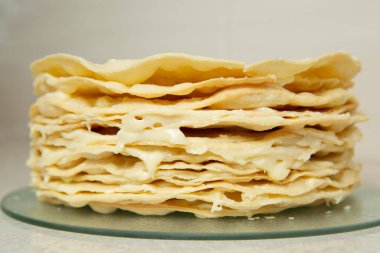 Making homemade Napoleon cake. Many layers of cake smeared with a fragrant and delicious cream