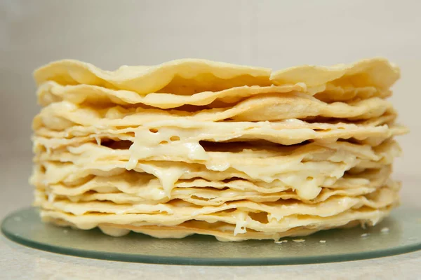Making homemade Napoleon cake. Many layers of cake smeared with a fragrant and delicious cream