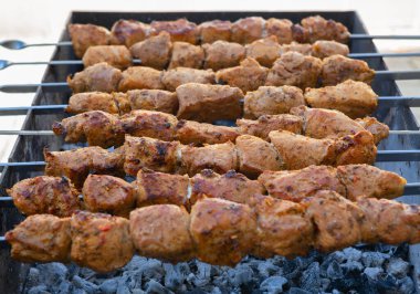Shish kebab is prepared on a charcoal grill