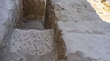 A staircase leads to the ancient Egyptian pyramid of Cheops. Rough stone steps close-up. Dense joints of masonry are visible. Giza.