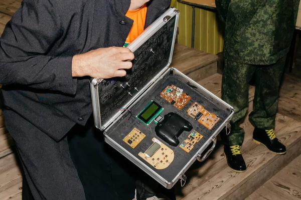 Box with electronics in hands at a themed game