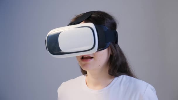 Seorang wanita dalam kacamata realitas maya memutar kepalanya ke samping. — Stok Video