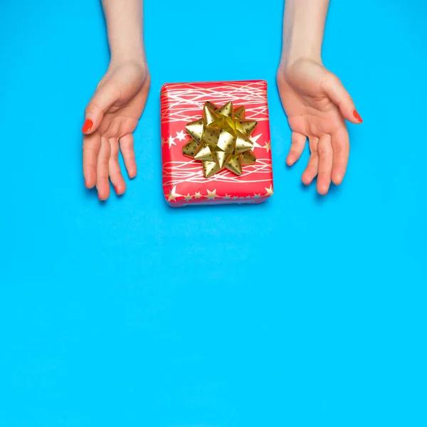 Gyönyörű piros ajándék doboz íj a nők kezében, felülnézet, másolás helyet szöveg. — Stock Fotó