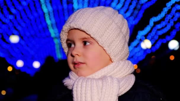 Handsome Child White Hat Smiles Standing Christmas Garlands Evening — Wideo stockowe