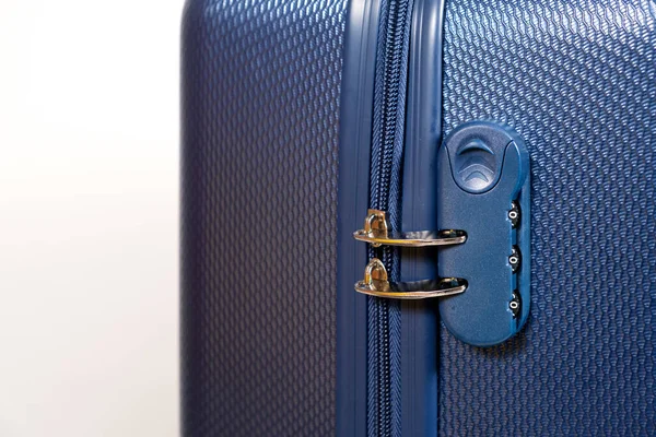 Kombinasyon kilidi ve kapalı fermuarlar beyaz arka planda mavi bir seyahat valizinde. Seyahat güvenliği.