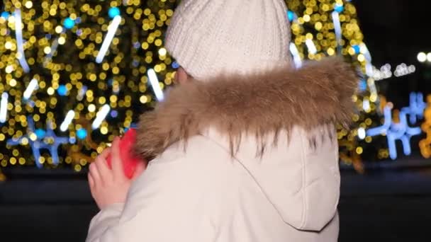 Beautiful Woman White Hat Jacket Holds Red Gift Christmas Tree — Stockvideo