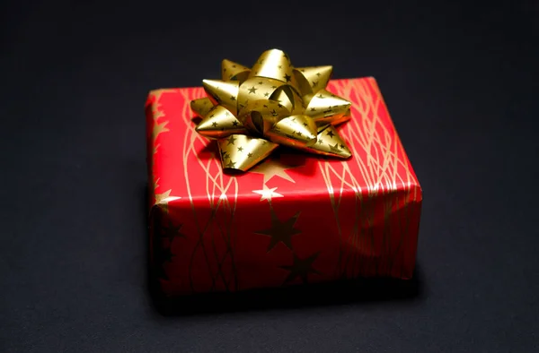 Caja Regalo Cuadrada Roja Con Lazo Dorado Sobre Fondo Negro — Foto de Stock