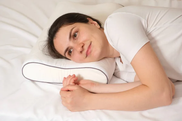 Woman Lies Her Side Orthopedic Pillow Looks Smiling — Stock Photo, Image