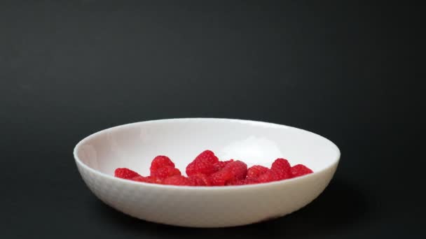 Raspberries Fall White Plate Black Background Side View Slow Motion — Stockvideo