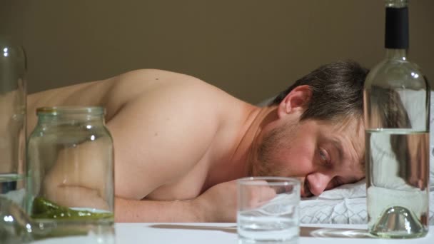 Drunk Man Lies Bed Drinks Alcohol Glass — Vídeo de Stock