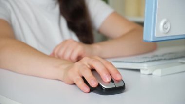 A woman has a sore wrist after working at the computer, tunnel syndrome.