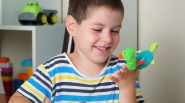 Mother and son play finger theater, toys on fingers