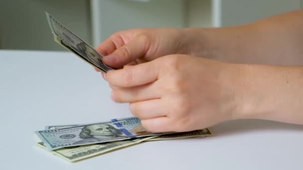 Woman Counts Dollar Bills 100 Dollars White Background — Stockvideo