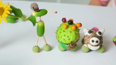 Animal figurines made of acorns, chestnuts and cones are autumn childrens crafts.