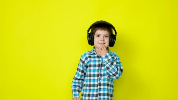 Boy Headphones Touches His Chin His Hand Goes Forward Yellow — Stock Video