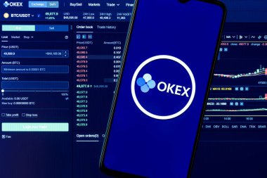 Kazan, Rusya - 7 Ekim 2021: OKEx bir kripto döviz kurudur. Arkaplanda OKEx logosu olan akıllı bir telefon. Tamam, Ex gösterge paneli.