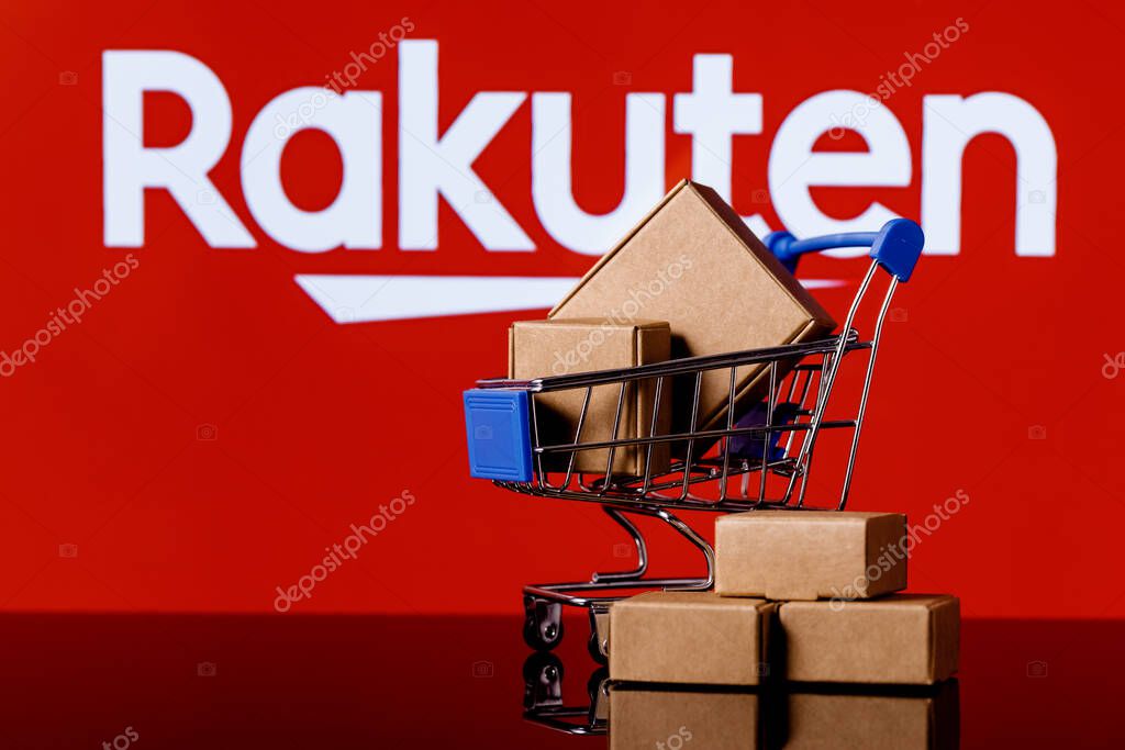 Kazan, Russia - Oct 12, 2021: Rakuten Group is Japanese electronic commerce and online retailing company. Shopping cart with parcels on the background of the Rakuten logo.