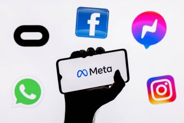 Kazan, Rusya - 28 Ekim 2021: Facebook adını Meta olarak değiştirdi. Facebook metaverse 'e ait ürünlerin logolarının arka planında Meta logosu olan akıllı telefon.