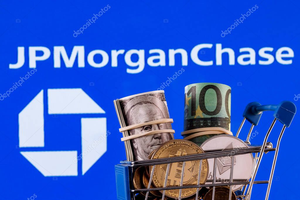 Kazan, Russia - Nov 24, 2021: Crypto and traditional currencies in shopping cart on background of JPMorgan Chase bank logo
