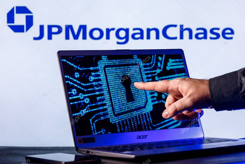 Kazan, Russia - Nov 24, 2021: Laptop with lock symbol on screen on background of  JPMorgan Chase bank logo. Finger points to lock symbol. Concept of data hacking.