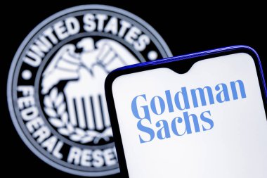 Kazan, Russia - Dec 20, 2021: Smartphone with Goldman Sachs bank logo on background of Federal Reserve symbol